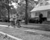 Two girls cycling in front of house Poster Print - Item # VARSAL2554526B