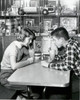 Side profile of a young couple drinking a milkshake in a restaurant  1954 Poster Print - Item # VARSAL2555476