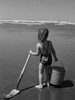 Girl holding bucket and spade on beach Poster Print - Item # VARSAL25514288