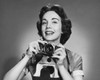 Portrait of a photographer holding a camera and smiling Poster Print - Item # VARSAL2557795