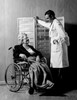 Doctor looking at senior patient in wheelchair Poster Print - Item # VARSAL255418724