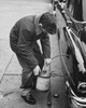 High angle view of a boy stealing gasoline from a car Poster Print - Item # VARSAL25549633