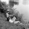 Boy fishing while girl is reading comic book Poster Print - Item # VARSAL25516371