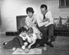 Two children playing cards with their parents looking at them Poster Print - Item # VARSAL25516056
