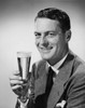 Portrait of a mature man holding a glass of beer Poster Print - Item # VARSAL25512634