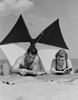 Young couple reading books on beach Poster Print - Item # VARSAL255422117