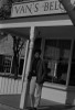 USA  Young woman standing on cafe's porch Poster Print - Item # VARSAL255424768