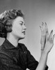 Side profile of a young woman looking at her fingernails Poster Print - Item # VARSAL25510586