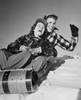 Low angle view of a young couple sliding on a sled Poster Print - Item # VARSAL25518611