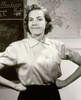 Portrait of a female teacher with arms akimbo in a classroom Poster Print - Item # VARSAL25517630