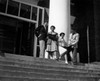 Low angle view of two young men and two young women reading books Poster Print - Item # VARSAL25518288