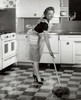 Portrait of a mid adult woman mopping the kitchen floor Poster Print - Item # VARSAL2552871