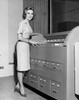 Portrait of a businesswoman standing beside a filing cabinet Poster Print - Item # VARSAL2555470