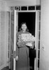 Woman carrying Christmas presents in doorway Poster Print - Item # VARSAL255422276