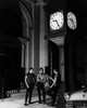 Three men having conversation outside bank at night Poster Print - Item # VARSAL25549575