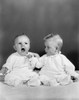 Two babies sitting together Poster Print