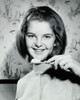 Portrait of a teenage girl holding a toothbrush and smiling  1966 Poster Print - Item # VARSAL25517444