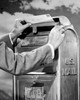 Man's hand dropping mail into a mailbox Poster Print