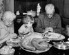 Senior couple praying with their granddaughter at a dining table on Thanksgiving Day Poster Print - Item # VARSAL2554934