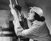 Young woman climbing a ladder and holding a flashlight Poster Print - Item # VARSAL2551068
