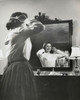 Side profile of a teenage girl combing her hair in front of a mirror Poster Print - Item # VARSAL25517417