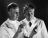 Two scientists analyzing chemicals in two test tubes Poster Print - Item # VARSAL2554458