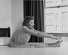 Side profile of a young woman stretching on the bed Poster Print - Item # VARSAL25540103