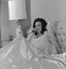 Woman talking on phone in bed Poster Print - Item # VARSAL255418132