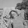 Senior man wearing hat and smoking pipe  fishing nets in the background Poster Print - Item # VARSAL255421645