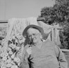 Senior man wearing hat and smoking pipe  fishing nets in the background Poster Print - Item # VARSAL255421645