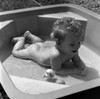 Naked baby lying on front in wading pool Poster Print - Item # VARSAL2559101