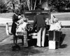 Parents and their children loading luggage into a car Poster Print - Item # VARSAL25542751