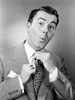 Portrait of mid adult businessman adjusting tie Poster Print - Item # VARSAL255417939