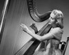 Side profile of a young woman playing a harp Poster Print - Item # VARSAL2553363