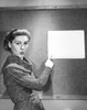 Portrait of a young woman pointing towards a paper Poster Print - Item # VARSAL25528098B