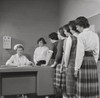 Teenage girls standing in a row beside a nurse's desk Poster Print - Item # VARSAL25533927
