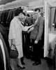 Woman assisting man trying on suit in shop Poster Print - Item # VARSAL255417872