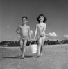 Boy and girl carrying bucket on beach Poster Print - Item # VARSAL255418016