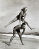 Young couple playing leapfrog on the beach Poster Print - Item # VARSAL25516453