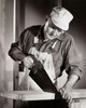 Carpenter sawing a wooden plank Poster Print - Item # VARSAL2551292