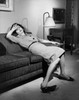 Young woman resting on a couch Poster Print - Item # VARSAL255955