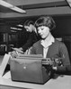 Young woman typing a document on a typewriter in an office Poster Print - Item # VARSAL25548804