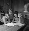 Mother with sons doing homework Poster Print