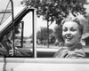 Close-up view of young woman sitting in car and smiling Poster Print - Item # VARSAL25526009