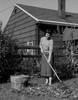 Smiling young woman raking dead leaves Poster Print - Item # VARSAL255422107
