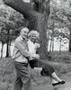 Side profile of a senior man pushing a senior woman on a swing Poster Print - Item # VARSAL2553446