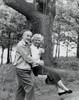 Side profile of a senior man pushing a senior woman on a swing Poster Print - Item # VARSAL2553446