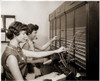 Side profile of two female telephone operators operating a switchboard Poster Print - Item # VARSAL25525132