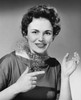 Portrait of a mid adult woman pointing with her finger and smiling Poster Print - Item # VARSAL25550190