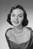 Studio portrait of young woman wearing necklace smiling Poster Print - Item # VARSAL255422833